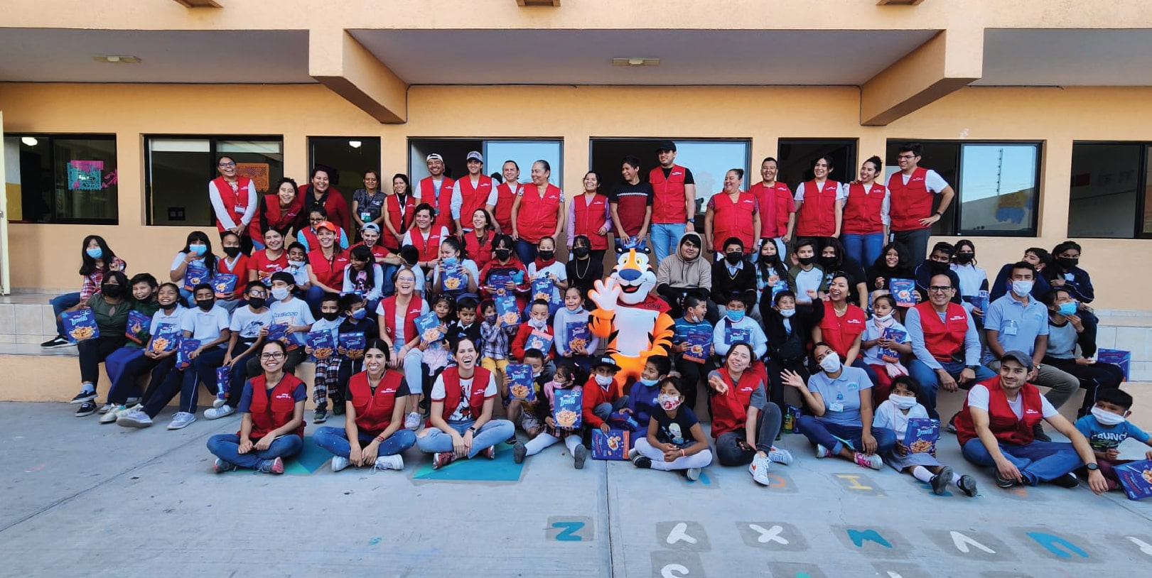Equipo de voluntarios, niños y Tigre Toño®